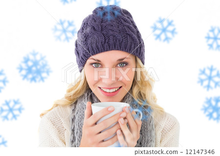 Composite image of pretty blonde in winter fashion holding mug Composite image of pretty blonde in winter fashion holding mug 12147346