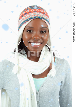 Composite image of smiling young woman in winter clothes Composite image of smiling young woman in winter clothes 12147348