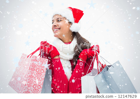 Composite image of beautiful festive woman holding shopping bags 12147629
