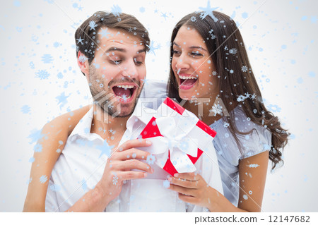 Composite image of pretty brunette surprising boyfriend with a g 12147682