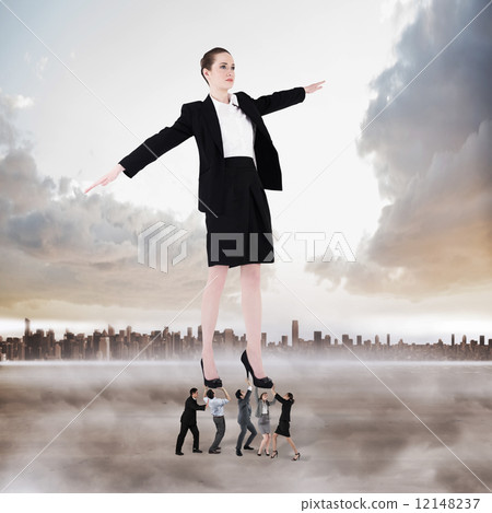 Composite image of business team supporting boss Composite image of business team supporting boss 12148237