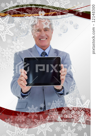 Composite image of smiling mature tradesman presenting screen of Composite image of smiling mature tradesman presenting screen of 12148300
