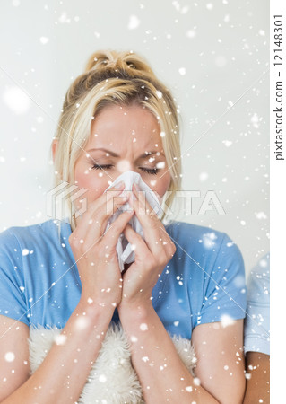 Composite image of closeup of a young woman suffering from cold Composite image of closeup of a young woman suffering from cold 12148301