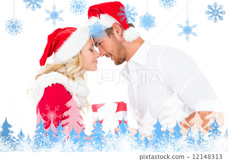 Composite image of festive young couple exchanging presents 12148313