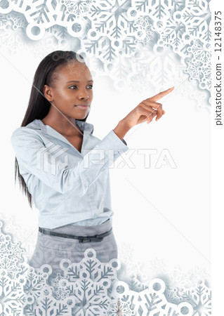 Composite image of portrait of a young businesswoman pressing an 12148375