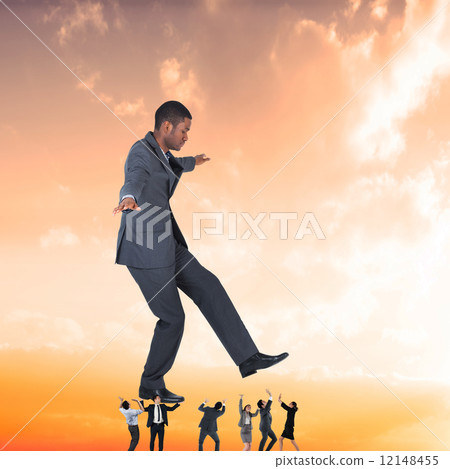 Composite image of business team supporting boss Composite image of business team supporting boss 12148455
