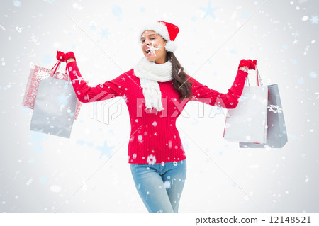 Composite image of beautiful festive woman holding shopping bags 12148521