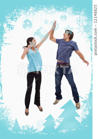 Composite image of portrait of a couple jumping together 12148825