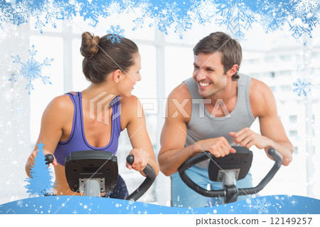 Smiling young couple working out at spinning class 12149257
