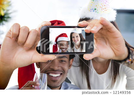 Composite image of hand holding smartphone showing 12149356