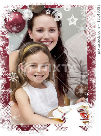 Mother and daughter having dinner with their family 12149385