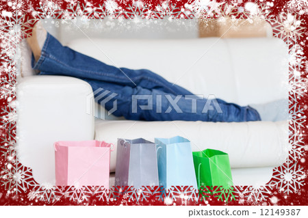 Female legs resting on sofa after shopping tour 12149387