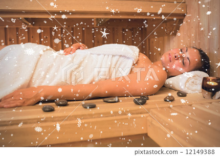 Peaceful brunette woman lying in a sauna 12149388