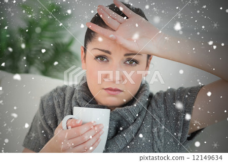Composite image of ill woman sitting on the couch in a living ro Composite image of ill woman sitting on the couch in a living ro 12149634
