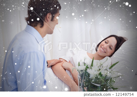 Composite image of man visiting his girlfriend in the hospital 12149754