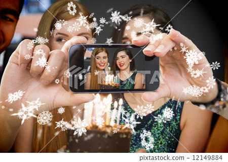 Hand holding smartphone showing photo 12149884