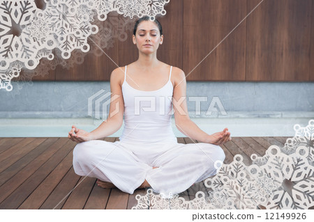Peaceful woman in white sitting in lotus pose 12149926