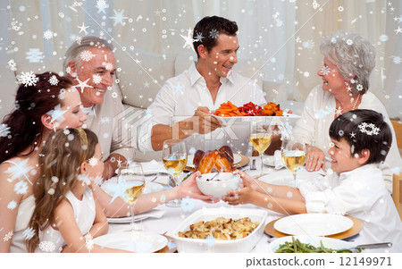 Composite image of family having a big dinner at home Composite image of family having a big dinner at home 12149971