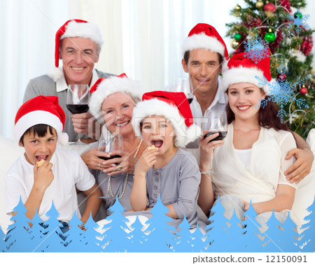 Family drinking wine and eating sweets in christmas 12150091