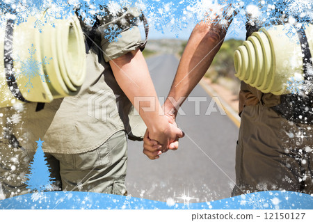 Hitch hiking couple standing holding hands on the road 12150127