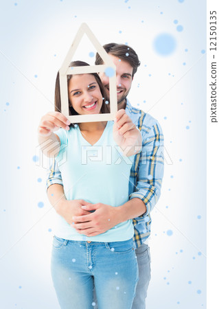 Happy young couple with house shape Happy young couple with house shape 12150135