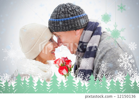 Happy mature couple in winter clothes with roses 12150136
