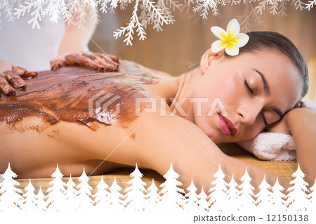 Attractive woman receiving chocolate back mask at spa center Attractive woman receiving chocolate back mask at spa center 12150138