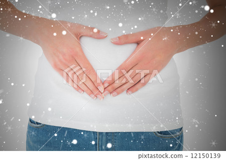 Mid section of a casual woman with stomach pain Mid section of a casual woman with stomach pain 12150139