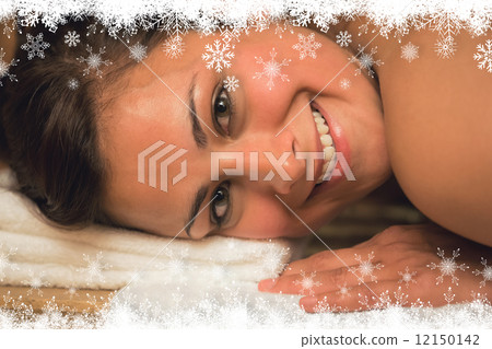 Happy brunette lying in a sauna looking at camera Happy brunette lying in a sauna looking at camera 12150142