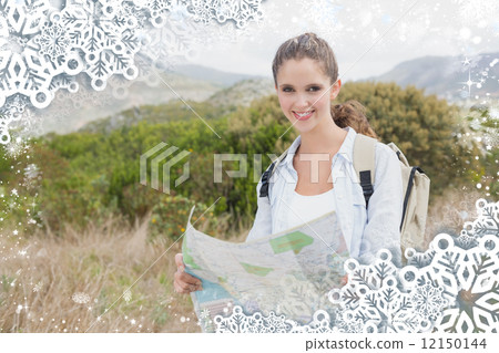 Portrait of a hiking young woman holding map Portrait of a hiking young woman holding map 12150144