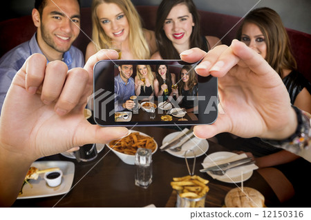 Composite image of hand holding smartphone showing Composite image of hand holding smartphone showing 12150316