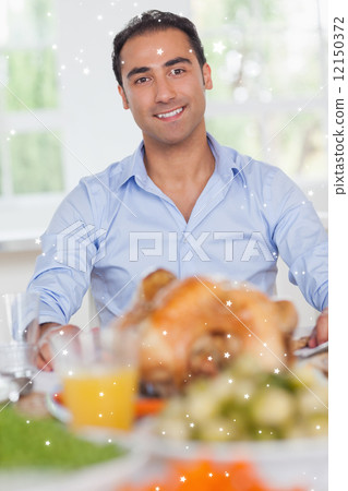 Man sitting at head of dinner table Man sitting at head of dinner table 12150372
