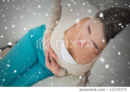 Composite image of ill women lying on the sofa Composite image of ill women lying on the sofa 12150373