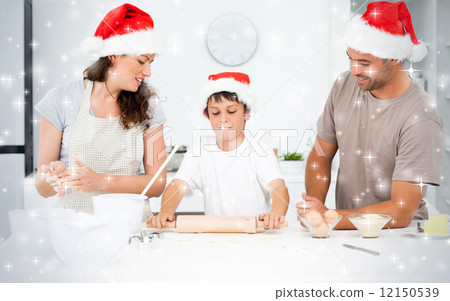 Composite image of proud parents looking at their son using a ro 12150539