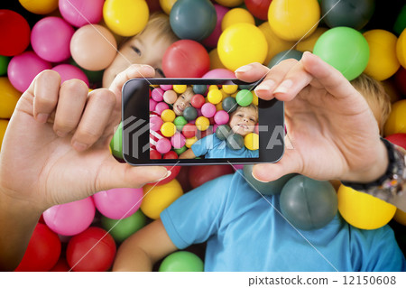 Composite image of hand holding smartphone showing Composite image of hand holding smartphone showing 12150608
