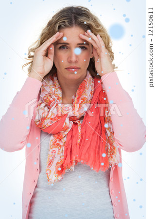 Blonde woman touching her temples because of a headache 12150611