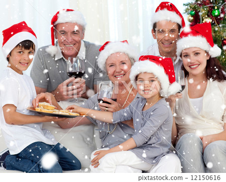 Composite image of family drinking wine and eating sweets in chr Composite image of family drinking wine and eating sweets in chr 12150616