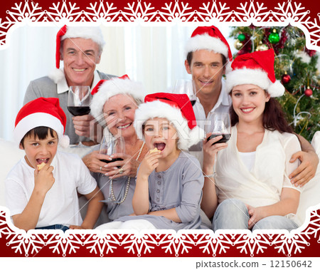 Family drinking wine and eating sweets in christmas 12150642