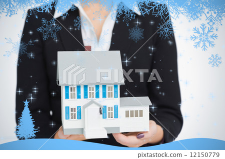 Real estate agent holding a model house Real estate agent holding a model house 12150779