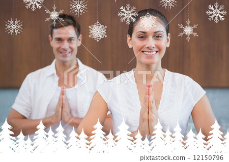Smiling couple in white sitting in lotus pose with hands together Smiling couple in white sitting in lotus pose with hands together 12150796