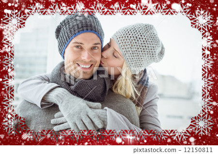 Cute couple in warm clothing hugging man smiling at camera Cute couple in warm clothing hugging man smiling at camera 12150811