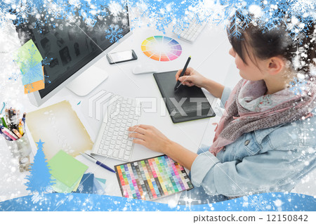 Artist drawing something on graphic tablet at office 12150842