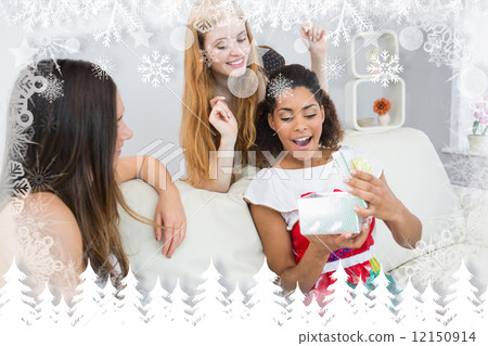 Composite image of cheerful young women surprising friend with a 12150914