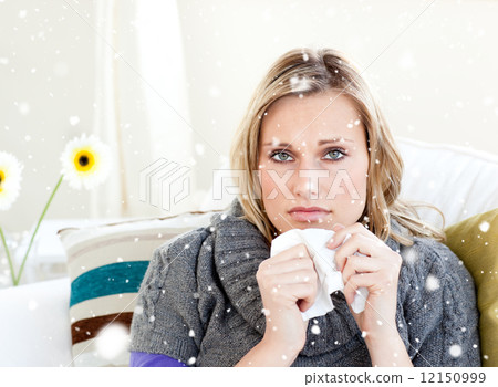 Composite image of unhealthy woman sitting on a sofa Composite image of unhealthy woman sitting on a sofa 12150999