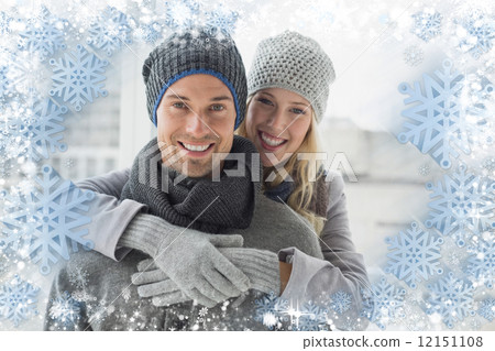 Cute couple in warm clothing hugging smiling at camera Cute couple in warm clothing hugging smiling at camera 12151108