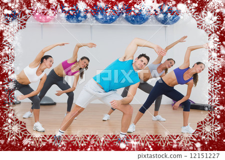 Class doing stretching exercise in fitness studio Class doing stretching exercise in fitness studio 12151227