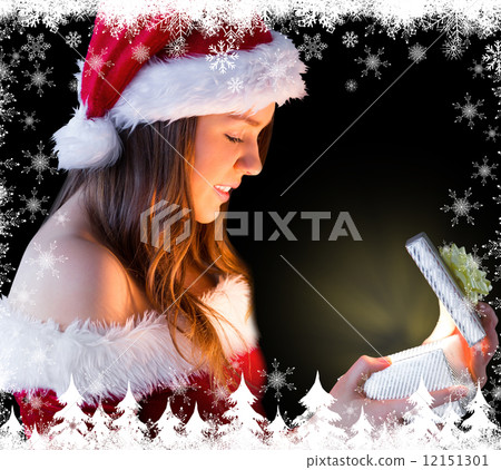 Pretty brunette in santa outfit opening gift 12151301
