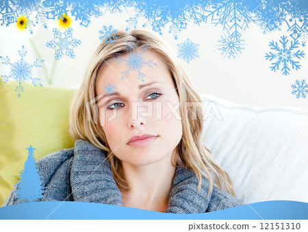 Exhausted woman lying on the sofa with a grey pullover 12151310