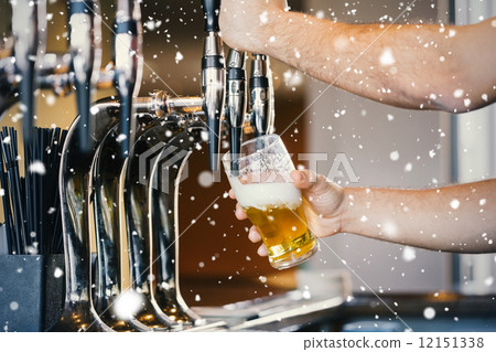Composite image of barmans arms pulling a pint of beer 12151338