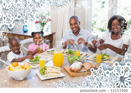 Happy family enjoying a healthy meal together Happy family enjoying a healthy meal together 12151406